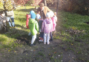 Dzieci udeptują ziemię wokół sadzonki