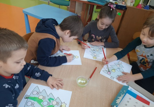 Dzieci malują przy użycia pędzla i wody