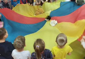 W trakcie zabaw z chustą animacyjną dzieci kołysały misia, bujały na falach...
